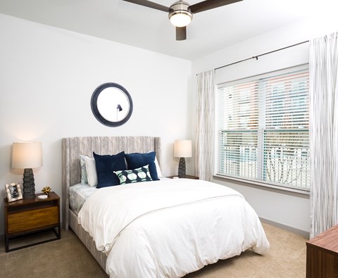 a bedroom with a large bed and a window