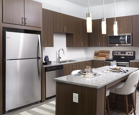 a kitchen with stainless steel appliances and a granite counter top