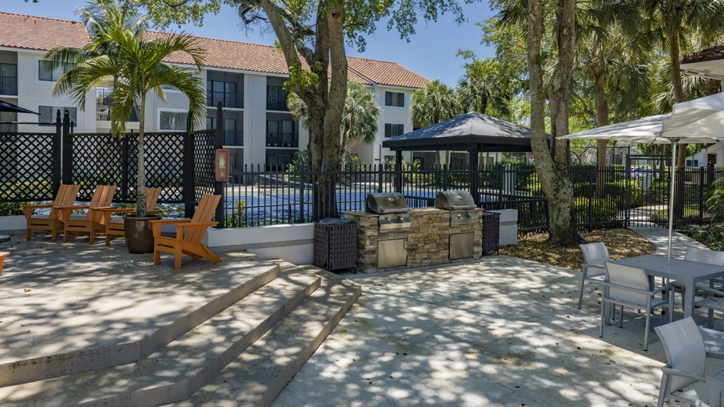 a patio with tables and chairs and a swimming pool