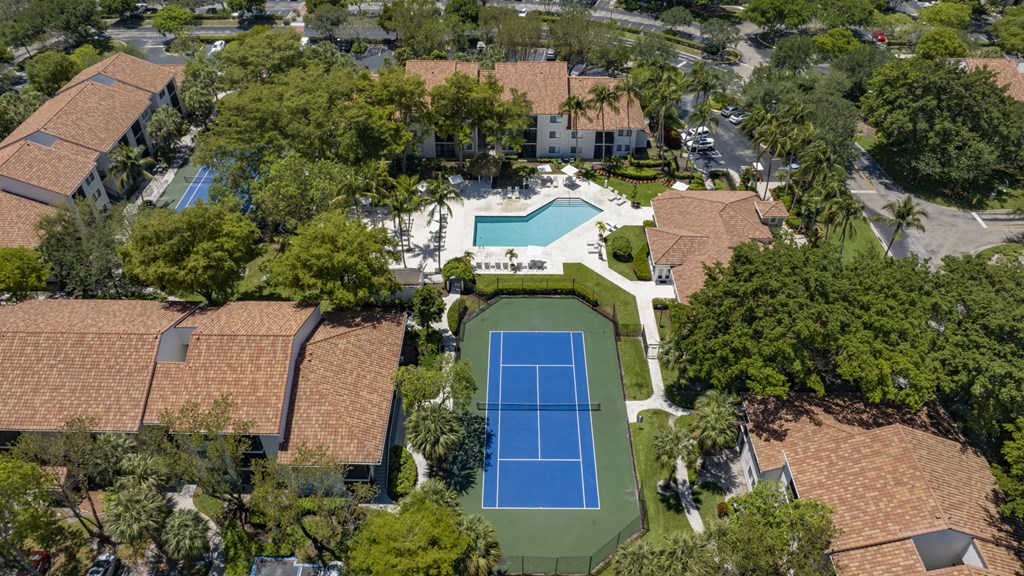 a birds eye view of a house with a tennis court and a pool