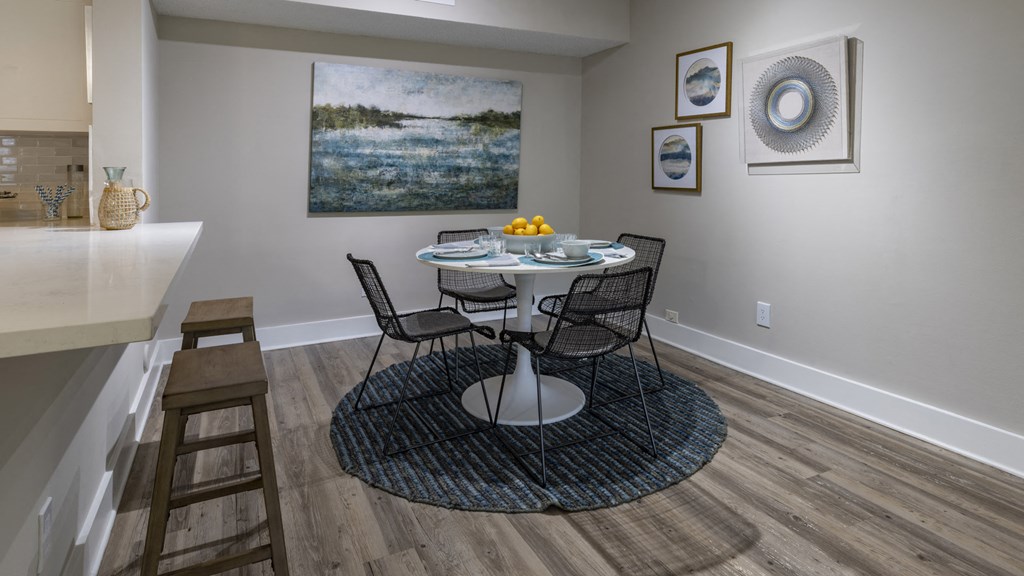 a dining room with a table and chairs and a kitchen