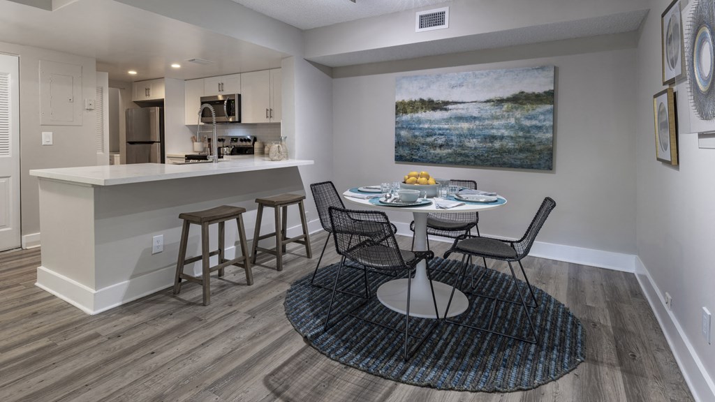 an open kitchen and dining room with a table and chairs