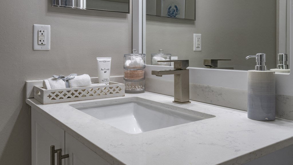 a bathroom with a sink and a mirror