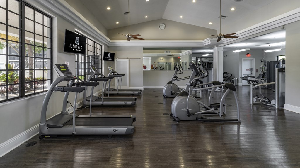 a gym with treadmills and other exercise equipment