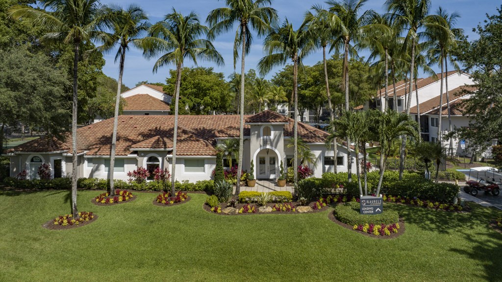 a mansion with palm trees in front of it