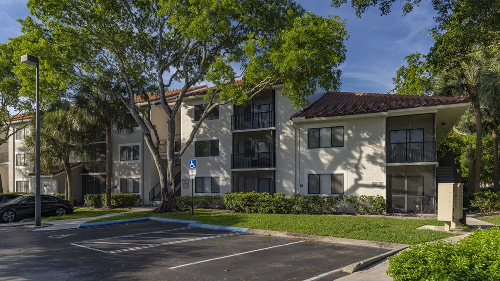 a parking lot in front of an apartment building