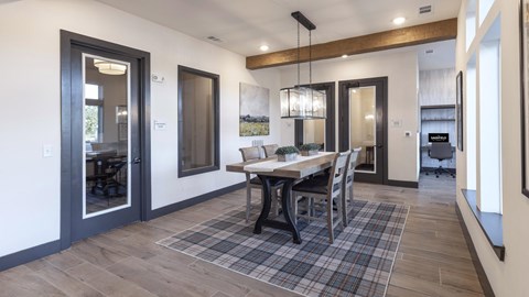 A modern dining room with a wooden table and chairs.