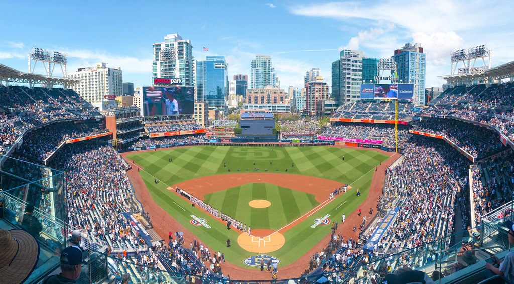 a view of a baseball stadium with a city in the background