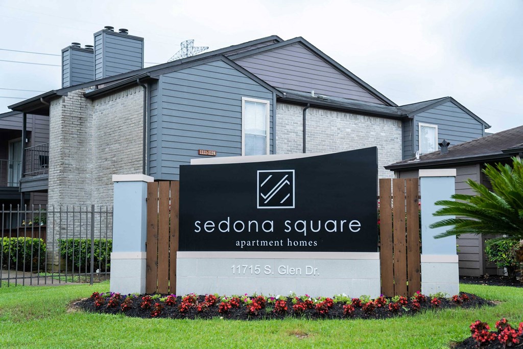 a sign square apartment homes in front of a house