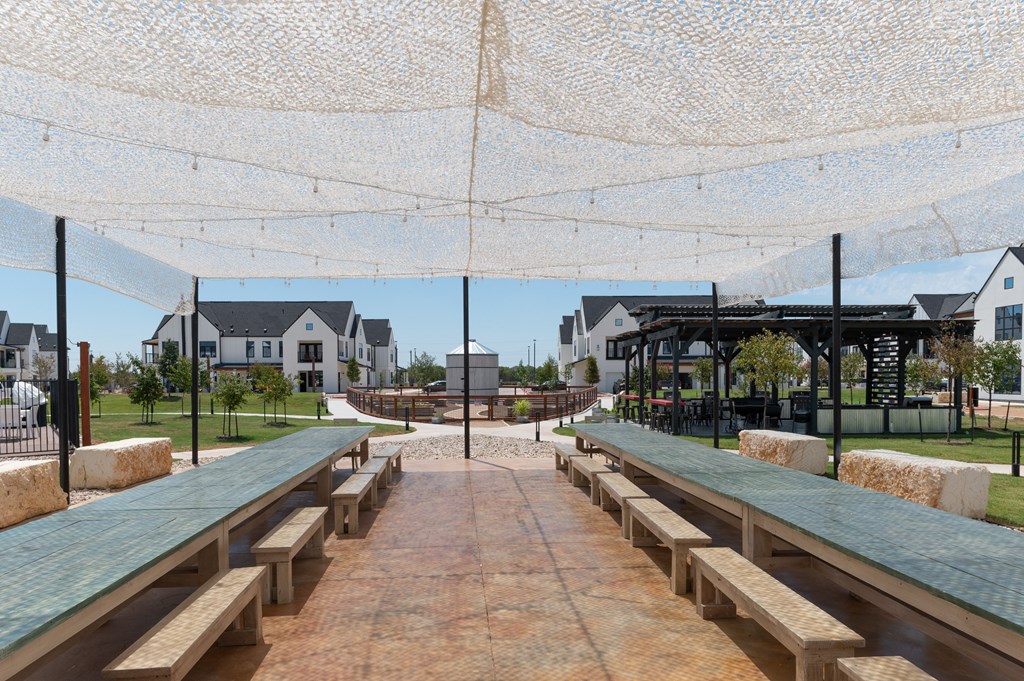 A covered walkway with benches and a canopy.