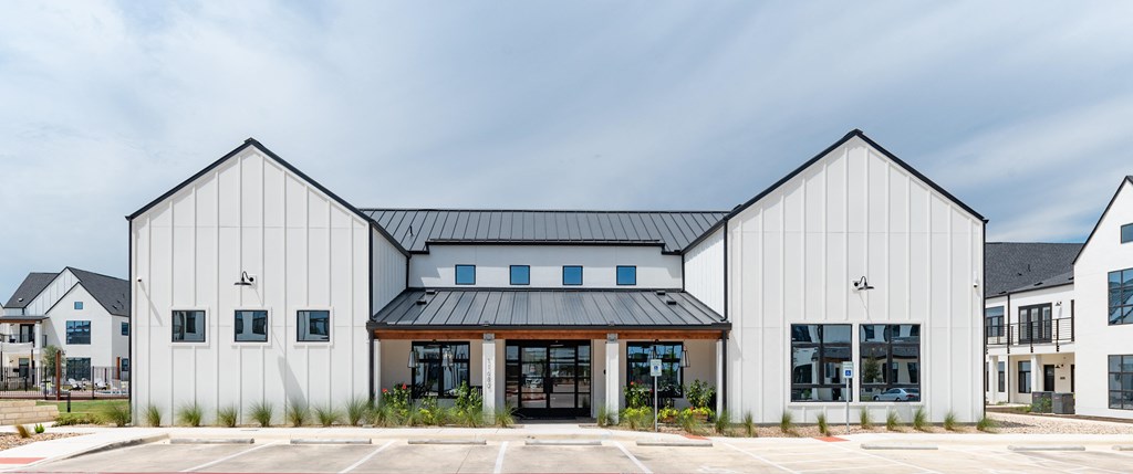 A modern building with a black roof and white walls.
