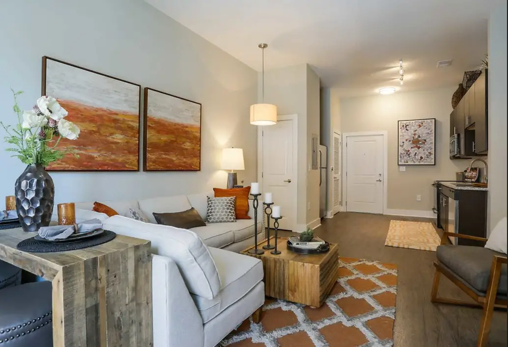 a living room with a white couch and a wooden coffee table