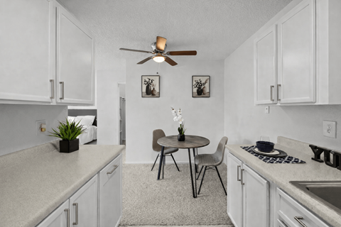 A small kitchen with a table and chairs.