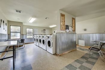 A laundry room with a washer and dryer stacked on top of each other.