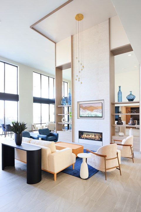 A living room with a fireplace and a painting on the wall.