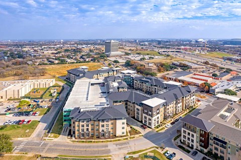 an aerial view of a group of buildings with gray roofs