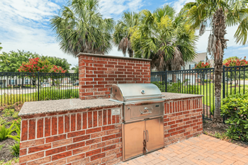A brick wall with a metal grill on top.
