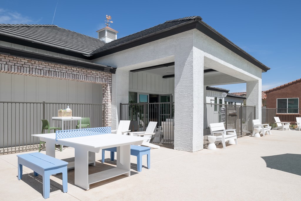 A white and blue table set up outside a house.