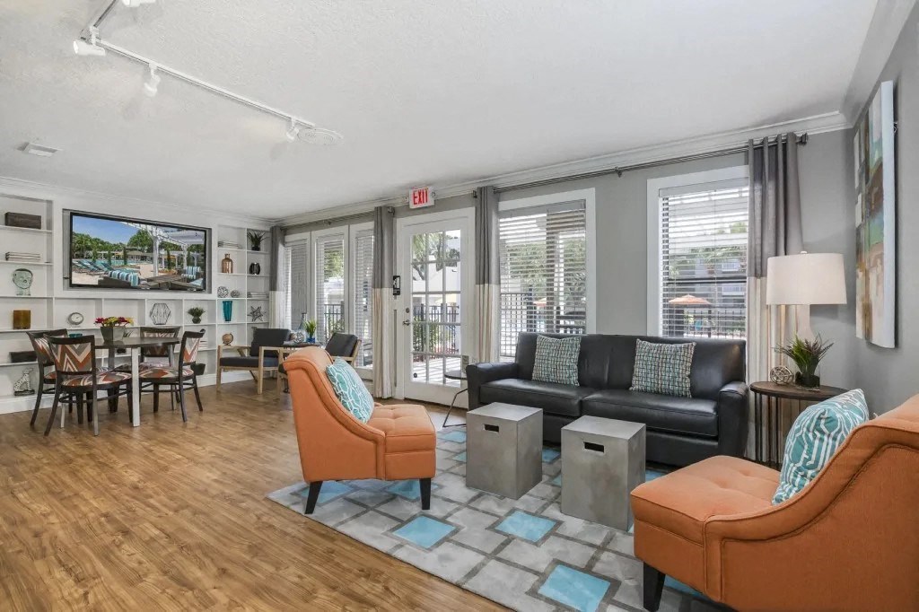 a living room with couches and chairs and a dining room table