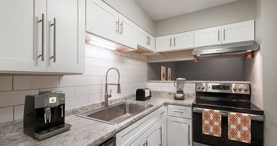 a kitchen with a sink and a stove