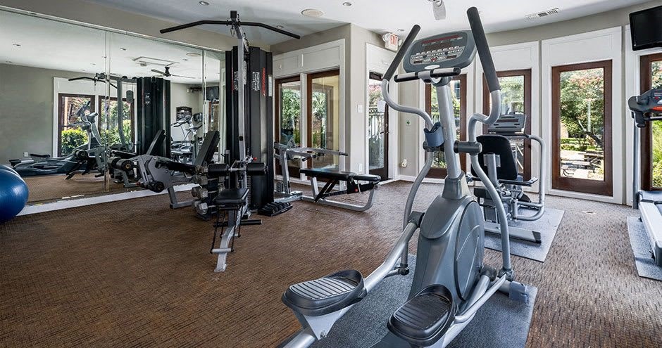 a gym with a lot of exercise equipment in it