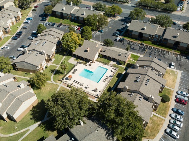 an aerial view of a neighborhood of houses and a swimming pool