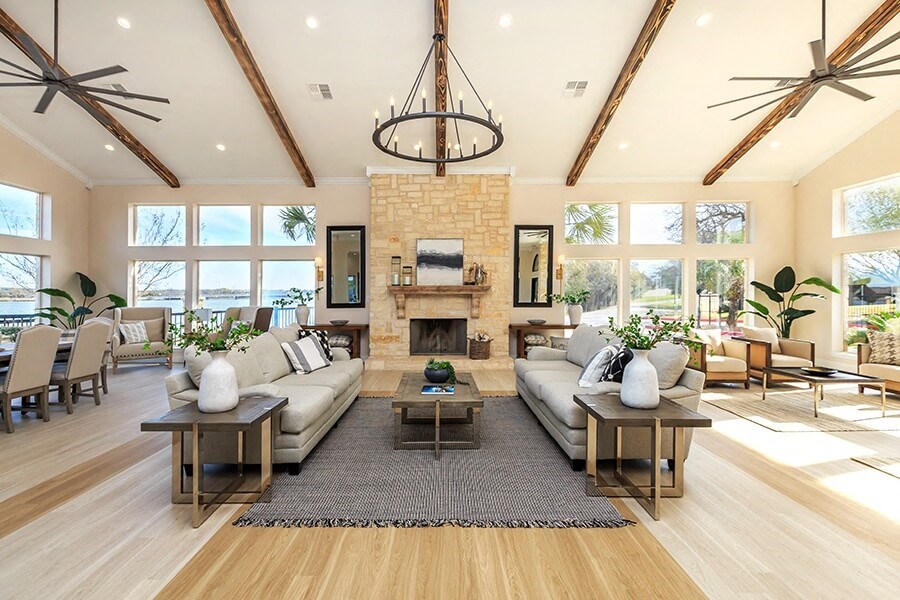 A spacious living room with a fireplace and a large rug.