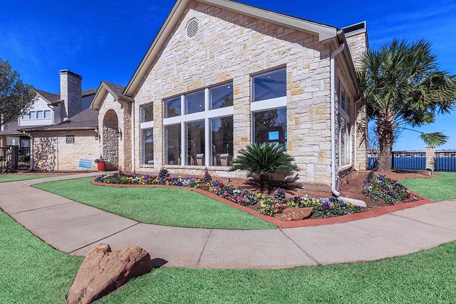 A house with a stone facade and a large front yard.