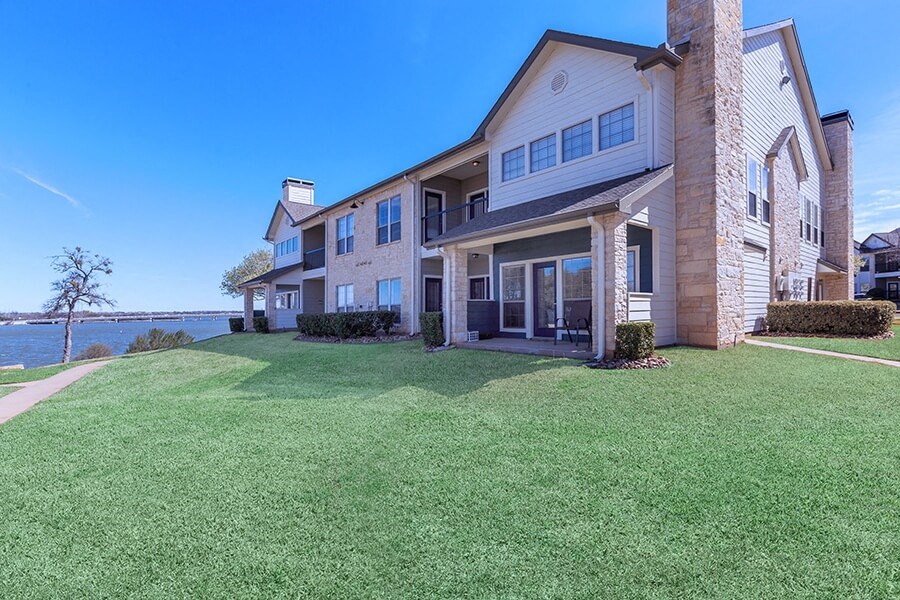 A large house with a well-manicured lawn in front.
