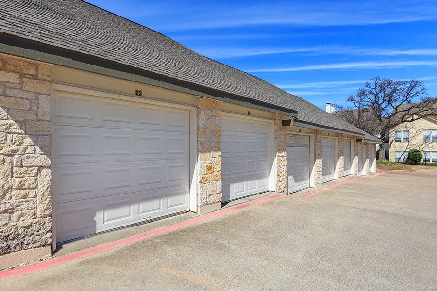 A row of garage doors are closed and numbered 21 to 23.