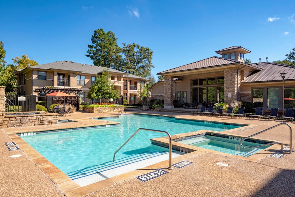 our apartments offer a swimming pool and a spa with a building in the background