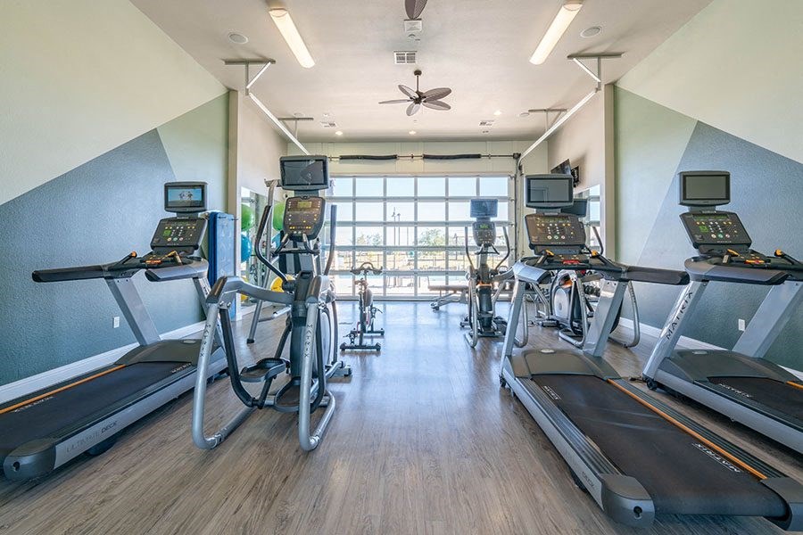 A gym with treadmills and exercise bikes.