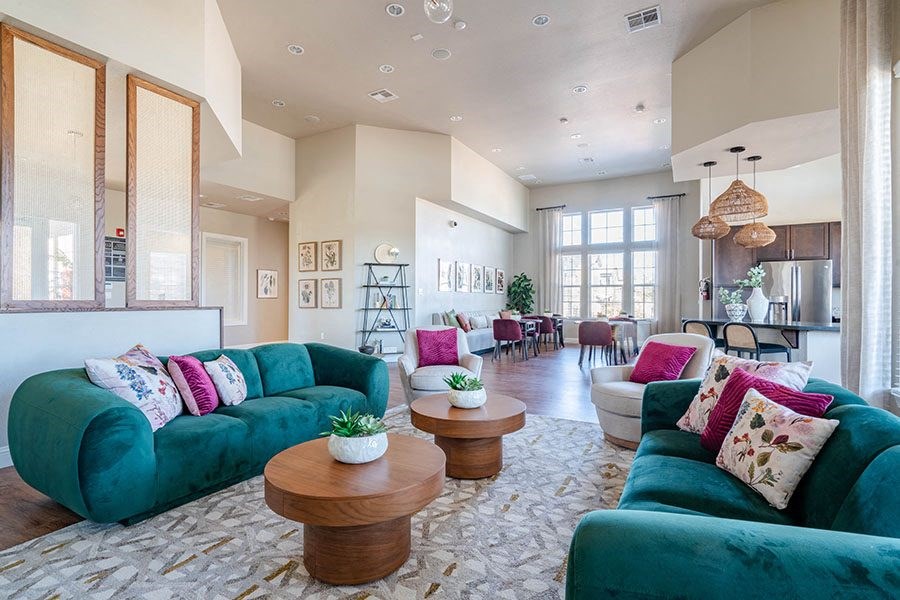 A living room with a green couch and a wooden coffee table.