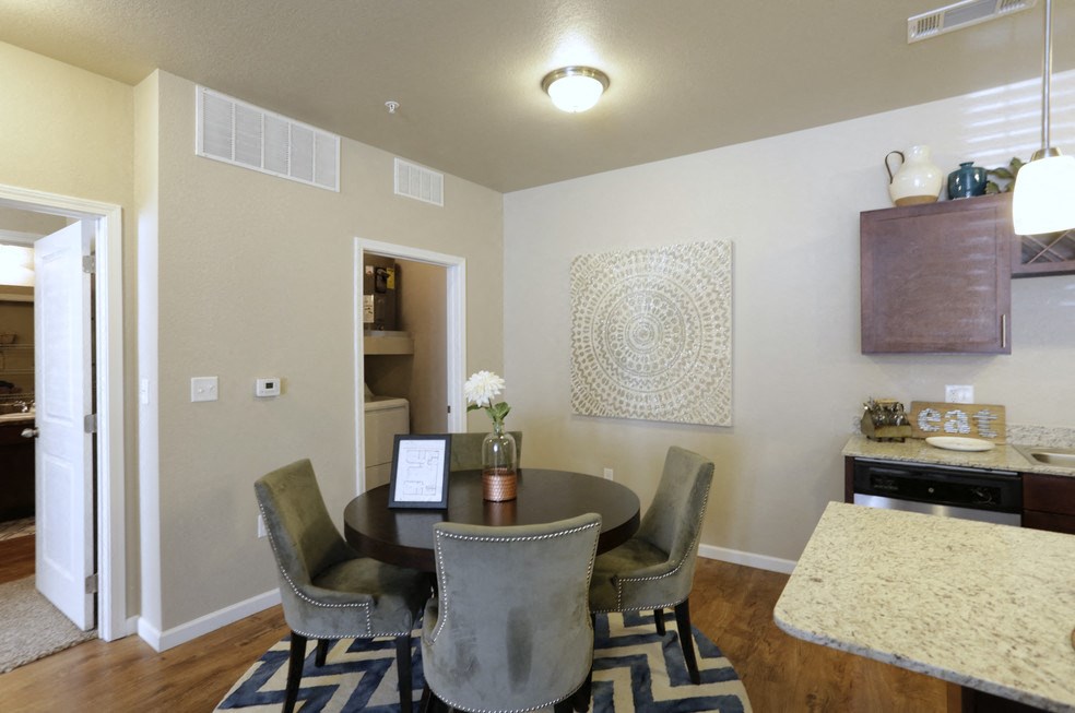 A dining room with a table set for four.