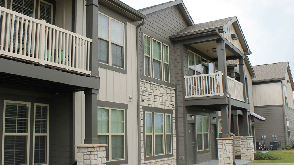 A row of houses with balconies and windows.