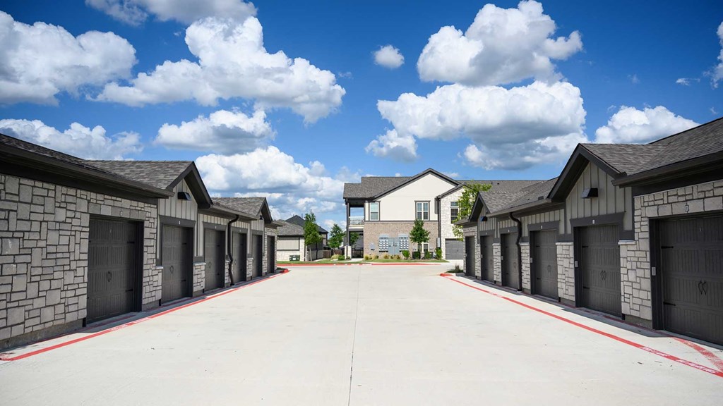 A row of houses with garages on the side.