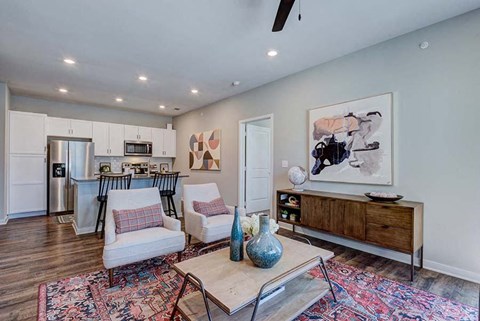 A living room with a white sofa and a wooden coffee table.