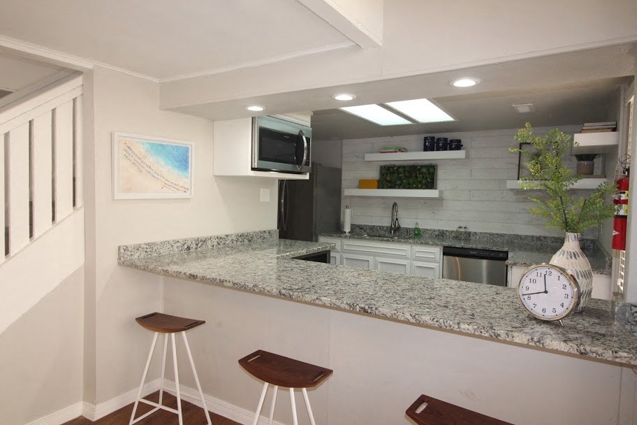 a kitchen with a counter top and a clock