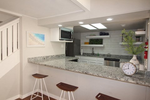 a kitchen with a counter top and a clock