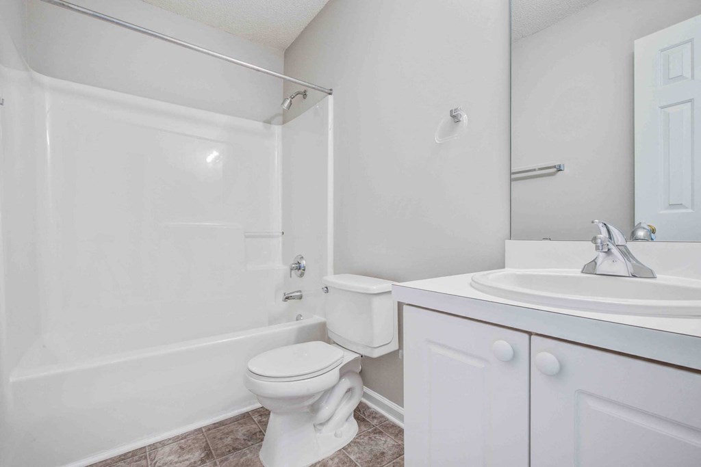a white bathroom with a sink and a toilet