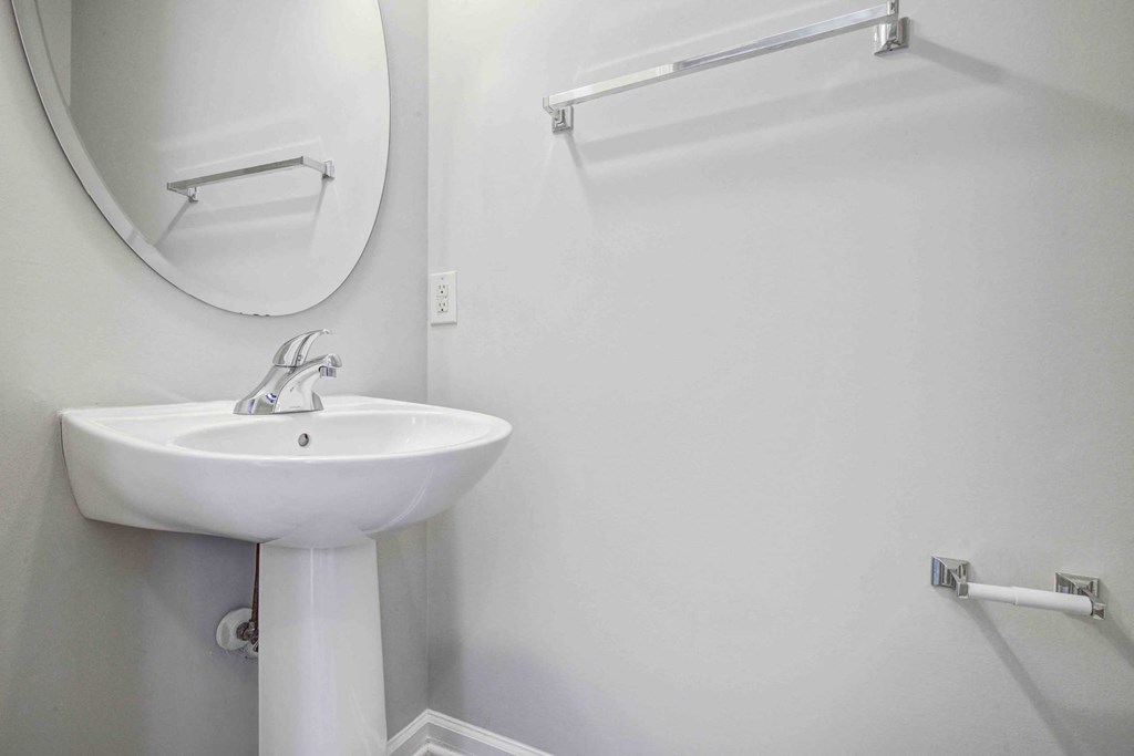 a white bathroom with a sink and a mirror