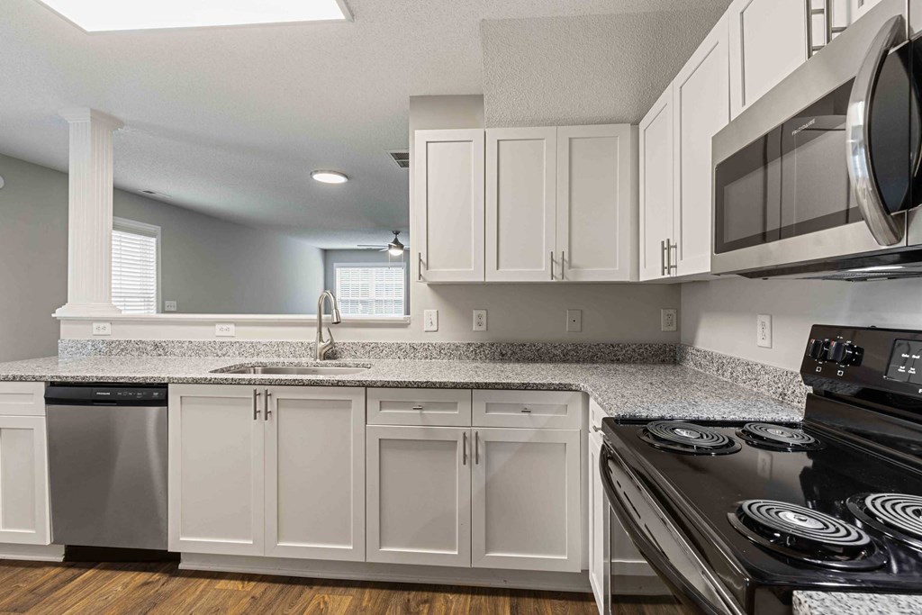 a kitchen with white cabinets and a counter top