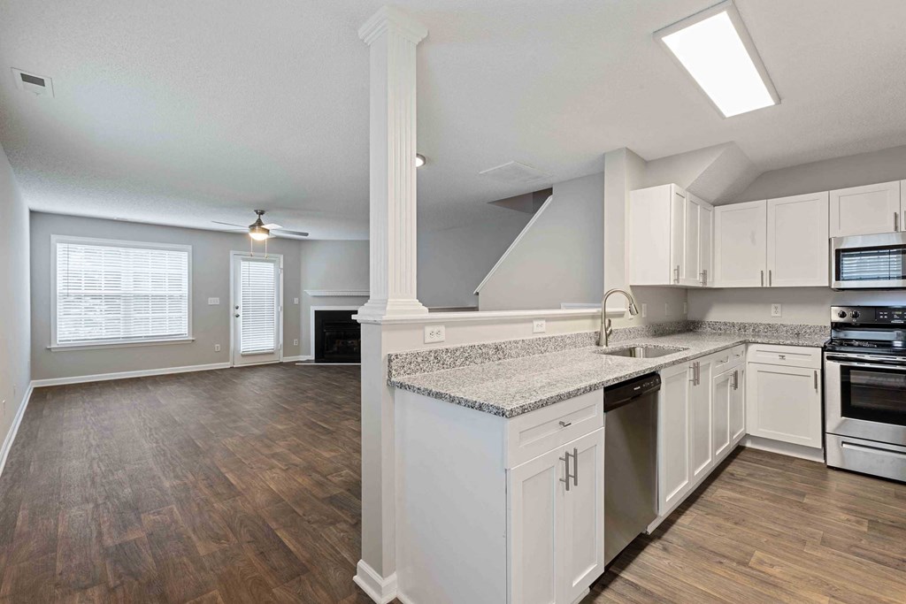 a kitchen with white cabinets and a counter top