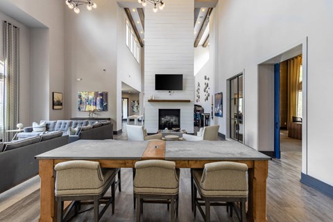 a living room with a table and chairs and a fireplace