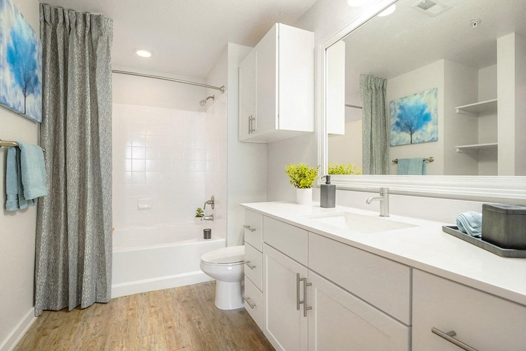 a white bathroom with a shower and a toilet