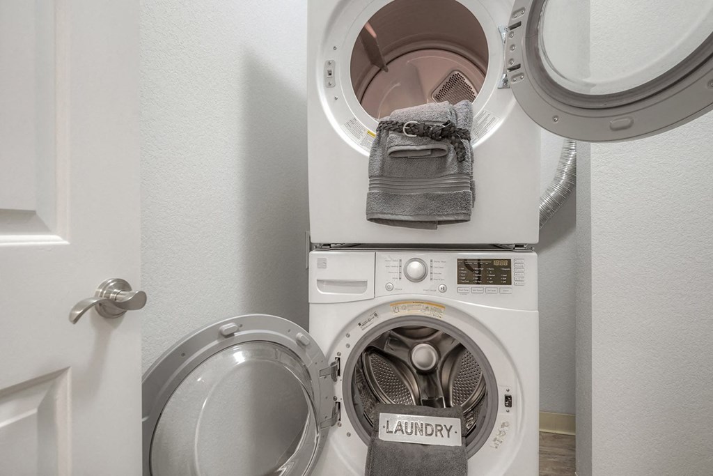 a washing machine and dryer in a small laundry room