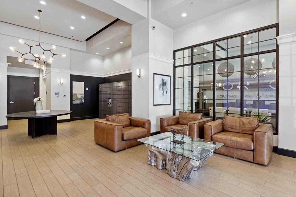 a large lobby with leather couches and a glass table