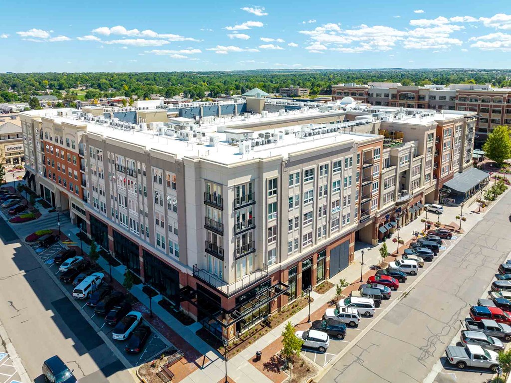 an aerial view of a large apartment building in a city