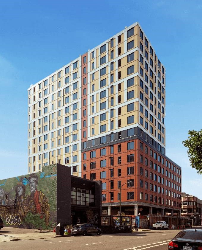 a tall building with a mural on the side of it