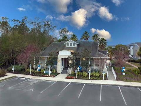 A parking lot in front of a building with a clear blue sky above.